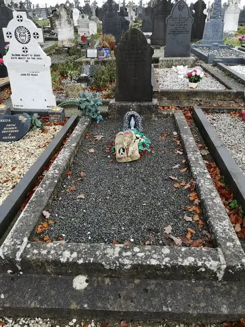 Before: grave covered in grey gravel with weeds coming through