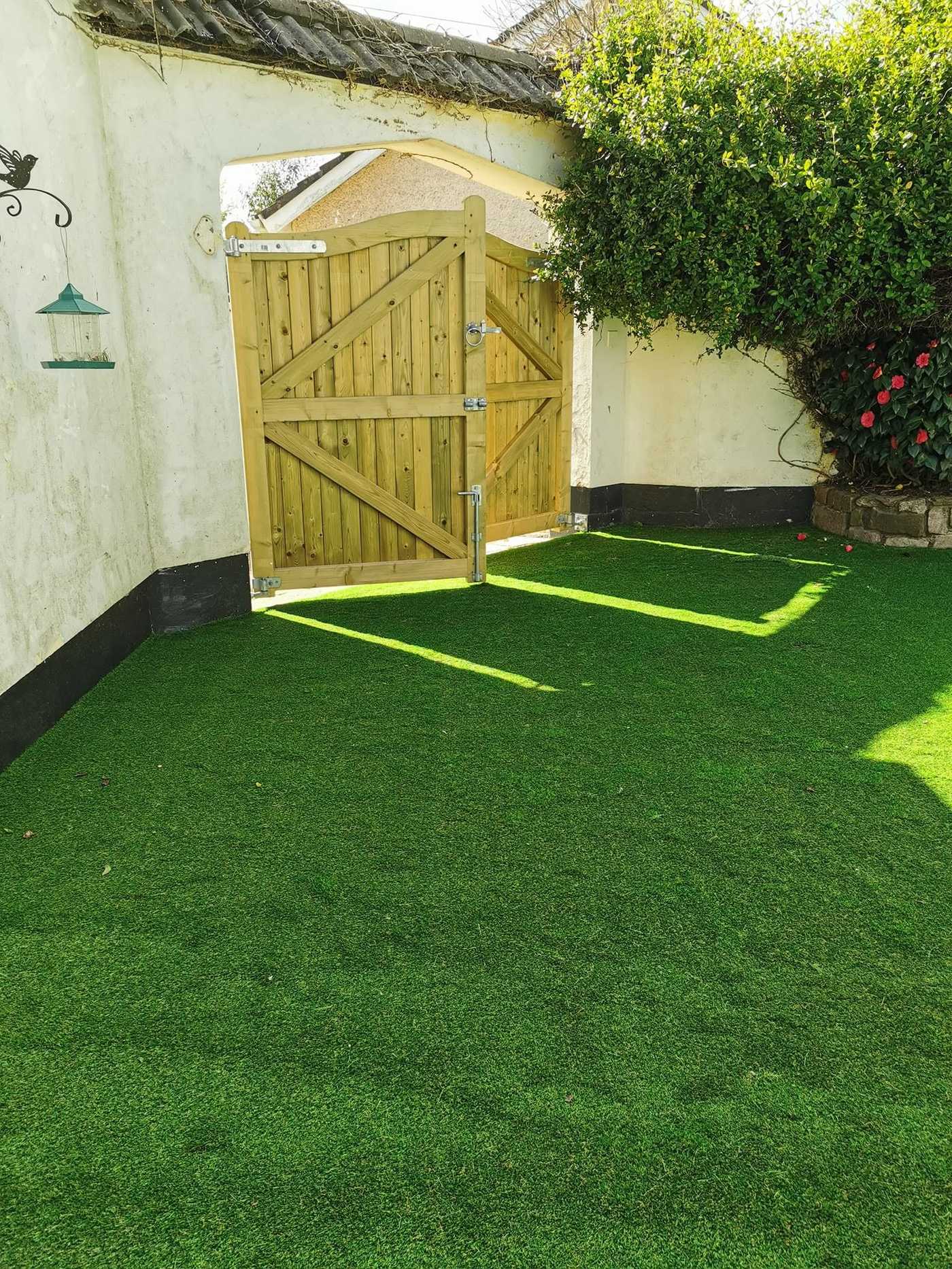 Small artificial lawn in front of a new timber side gate